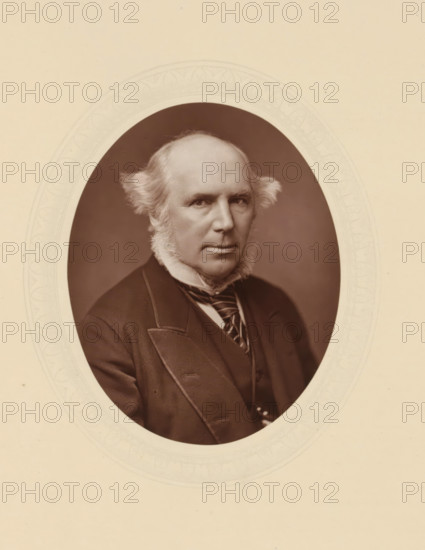 Dr. TH Tristram, page, photomechanical print, photographer: Lock & Whitfield, cliché maker: anonymous, c. 1877 - in or before 1882, paper, Woodburytype, Woodbury Process, height 115 mm x width 89 mm, Person, Thomas Hutchinson Tristram, lawyer, attorney at law, historical persons (portraits and scenes from the life) ((full) bust portrait), An oval sepia photograph of an older man with a high forehead and receding hairline, flanked by short, wispy side tufts, framed by ornate embossed oval matting on a light beige background; the man wears a dark formal coat with wide lapels, a vest, and a striped necktie, and he has prominent mutton-chop sideburns and a composed facial expression while looking slightly toward the viewer.
