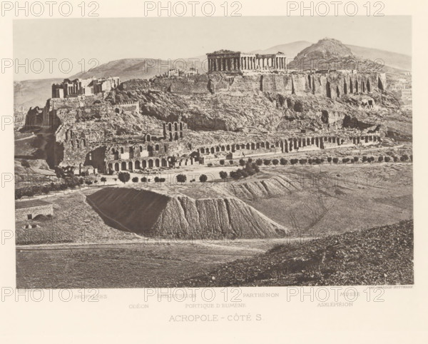 View of the Acropolis of Athens, Acropole-côté S, page, photomechanical print, inscription: 'Propylées, Asklépiéion', Athens, cliché maker: Dujardin, printer (person): Chardon-Wittmann, c. 1880 - in or before 1890, photographer, printer (person), Periféreia Protevoúsis, paper, photoaquatint, height 146 mm x width 213 mm, Print on frontispiece., city-view in general, 'veduta', Akropolis, A wide sepia-toned photograph of an elevated rocky plateau topped by ancient stone ruins, showing rows of tall columns and rectangular structures along the plateau edge, with steep rocky slopes descending to a lower terrace that contains a long series of arched stone openings and scattered ruined walls; in front of the terrace there are small trees aligned along a pathway and cultivated plots with furrowed earth and low ridges, while the foreground shows open textured fields and a deep cutaway of earth; distant rounded hills form the background under a pale sky.