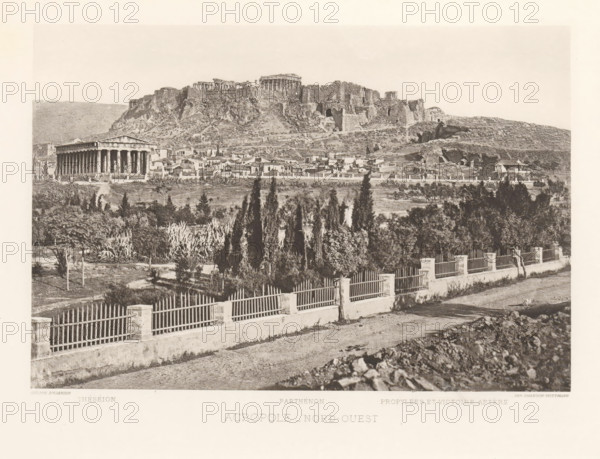 View of the Acropolis of Athens, Acropole- nord-ouest, page, photomechanical print, Athens, cliché maker: Dujardin, printer (person): Chardon-Wittmann, c. 1880 - in or before 1890, photographer, printer (person), Periféreia Protevoúsis, paper, photoaquatint, height 145 mm x width 215 mm, city-view in general, 'veduta', Akropolis, A wide sepia-toned view shows a rocky hill topped by ancient ruins with columns and stone structures, a lower area of clustered small buildings and houses at the hill's base, and a prominent rectangular temple with a colonnade standing apart from the houses. In the foreground a road runs parallel to a low wall topped by evenly spaced vertical railings and short square posts, behind which a planted area contains tall slender trees, dense shrubs, and other vegetation. The middle distance contains open grassy patches, scattered trees, and terraces leading up to the rugged slope of the hill, while the sky above is pale and mostly empty.