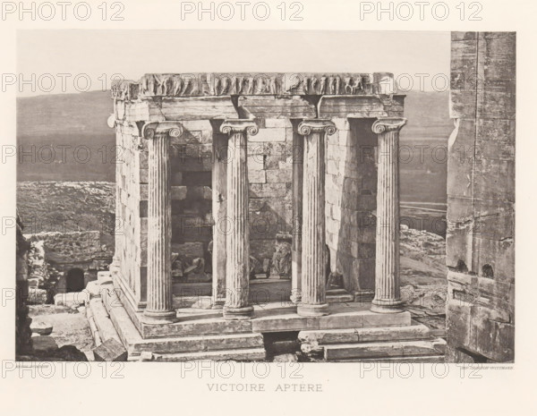 Temple of Athena Nikè on the Acropolis of Athens, Victoire aptère, page, photomechanical print, Athens, cliché maker: Dujardin, printer (person): Chardon-Wittmann, c. 1880 - in or before 1890, photographer, printer (person), Athene, Periféreia Protevoúsis, paper, photoaquatint, height 145 mm x width 215 mm, ruin of a building, architecture, temple, shrine, Greek religion, Acropolis, Temple of Athena Nikè, A stone structure with fluted columns and carved capitals stands on a stepped base, showing weathered blocks and worn surfaces; fragments of sculpted relief sit along the top edge, and broken stones and rubble lie around the base and interior; a partial statue or draped figure is visible among the ruins inside the columned space; a tall vertical stone wall is visible to the right, and a distant, hazy landscape stretches behind the ruins under a pale sky.
