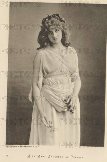 Miss Mary Anderson as Perdita, page, photomechanical print, photographer: Downey, William & Daniel, cliché maker: anonymous, c. 1883 - in or before 1893, paper, photoaquatint, height 216 mm x width 149 mm, Person, Mary Anderson, portrait of actor, actress, A sepia-toned portrait of a young woman standing and facing the camera with a gentle tilt of her head, wearing a light, draped, flowing dress with layered fabric gathered at the waist and over one shoulder, her wavy hair falling around her face and adorned with a wreath of leaves or flowers, her expression calm, one hand relaxed and hanging by her side holding a small bunch of flowers while the other hand lightly clasps fabric at her front, against a plain, softly shaded background.