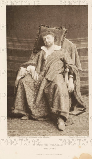 Osmond Tearle (King John), page, photomechanical print, photographer: Chancellor, Dublin, cliché maker: The Art Reproduction Company, publisher: Virtue & Co., London, c. 1880 - in or before 1890, Leinster, paper, photoaquatint, height 196 mm x width 121 mm, Person, portrait of actor, actress, A seated man wearing a patterned robe with a wide collar and large cuffs reclines against a cushioned chair with a fringed pillow behind his head; he has curly hair and a beard and his head tilts slightly to one side while one hand rests on his lap and the other hangs over the arm of the chair; the robe drapes over his legs and shows a row of buttons down the front, and he wears slippers with straps; a textured backdrop and carpeted floor are visible around the chair.