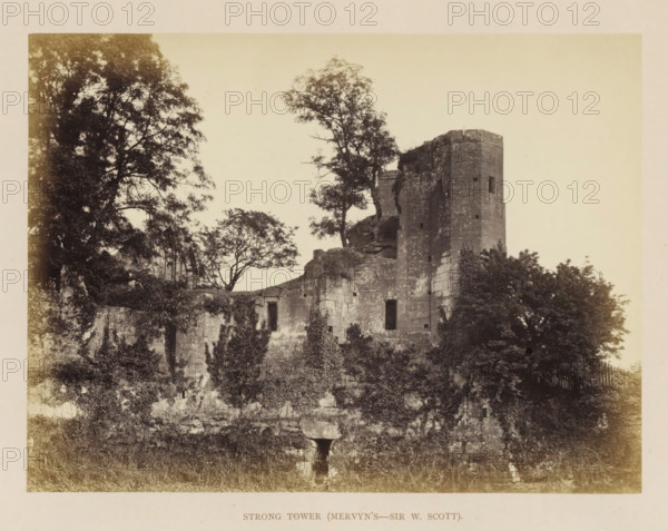 View of the ruins of the Strong Tower of Kenilworth Castle, Strong Tower (Mervyn's-Sir W. Scott), photograph, page, Kenilworth Castle, c. 1862 - in or before 1872, photographer, Kenilworth, paper, albumen print, height 152 mm x width 204 mm, ruin of a dwelling, house, castle, tower, clock tower, monumental adornment, A large stone ruin with a tall rounded tower and adjoining crumbling walls sits amid dense foliage, with trees growing behind and around the structure and vines climbing parts of the masonry, several rectangular openings visible in the stone, and a grassy foreground leading up to the weathered base of the ruin.