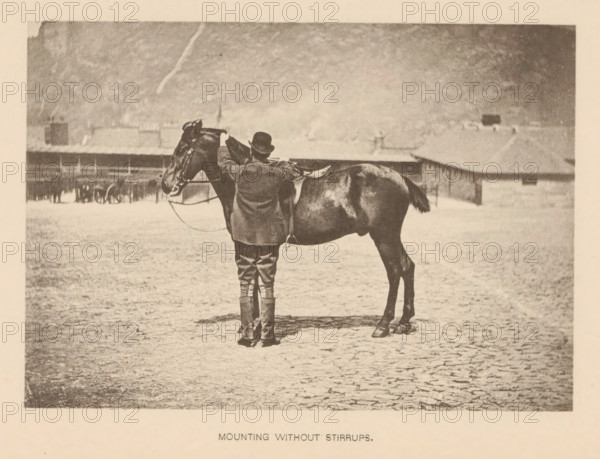 Mounting without Stirrups, Man mounting a horse without using the stirrups, page, photomechanical print, cliché maker: Römmler & Jonas, Dresden, c. 1879 - in or before 1889, photographer, paper, collotype, photoprint, height 96 mm x width 137 mm, horse, riding a horse, ass, or mule, rider, horseman, head-gear: bowler hat, A sepia-toned photograph shows a person standing behind a saddled horse in an open, flat area with a textured ground. The person wears a hat, a long coat, riding breeches, and high boots, and their hands rest on the horse's neck near the saddle. The horse faces left with visible bridle and reins, a shiny coat, and a tucked tail. In the background there are low buildings and a distant hillside under a pale sky.