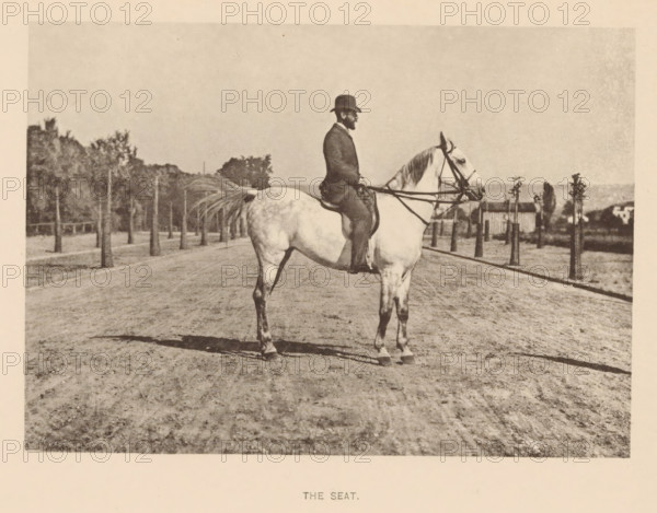 Man on a horse, The seat, page, photomechanical print, cliché maker: Römmler & Jonas, Dresden, c. 1879 - in or before 1889, photographer, paper, collotype, photoprint, height 97 mm x width 136 mm, horse, riding a horse, ass, or mule, rider, horseman, head-gear: bowler hat, A sepia-toned photograph of a person seated on a light-colored horse on a dirt road, the rider wearing a dark suit and a bowler-style hat and holding reins, the horse shown in profile facing to the right with a long tail and visible tack, a row of small trees lining the roadside behind them with a fence and larger trees farther back, a low building and distant structures visible near the horizon, and the foreground showing textured, rutted ground with the horse casting a shadow.