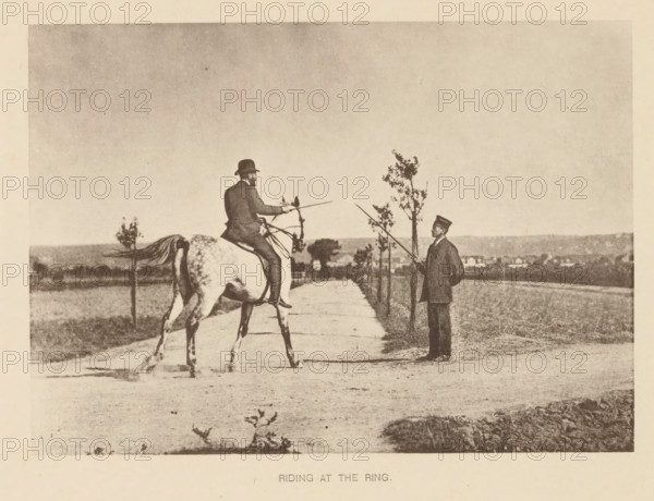 Man riding a horse and presumably going to joust, Riding at the ring, page, photomechanical print, cliché maker: Römmler & Jonas, Dresden, c. 1879 - in or before 1889, photographer, paper, collotype, photogravure, height 97 mm x width 136 mm, horse, riding a horse, ass, or mule, rider, horseman, head-gear: bowler hat, A sepia-toned photograph shows a man seated on a horse facing a second man standing on a dirt path lined with small trees; the rider wears a dark coat and a hat and holds a long, thin pole toward the standing man, who is dressed in a dark suit and cap and also holds a pole; the horse is light-colored with visible markings and a raised tail, and the background features open fields and distant low buildings under a wide, empty sky.
