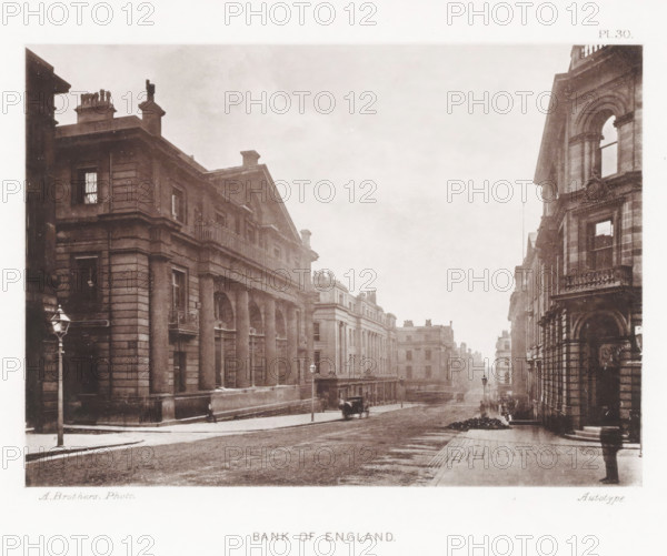 View of the Bank of England in Manchester, Bank of England, page, photomechanical print, number: 'Pl. 30.', photographer: Brothers, Alfred, Manchester, cliché maker: anonymous, c. 1868 - in or before 1878, printer (person), paper, collotype, photoprint, height 130 mm x width 180 mm, bench, facade (of house or building), A sepia-toned street scene shows rows of large stone buildings with classical facades, columns, balustrades, and tall windows lining both sides of a wide road. Old-fashioned lampposts stand along the pavement and a horse-drawn carriage is visible on the street. Stone steps and ornate architectural details appear on the building fronts, and a few indistinct figures are present on the sidewalks. The sky above is light and overcast.