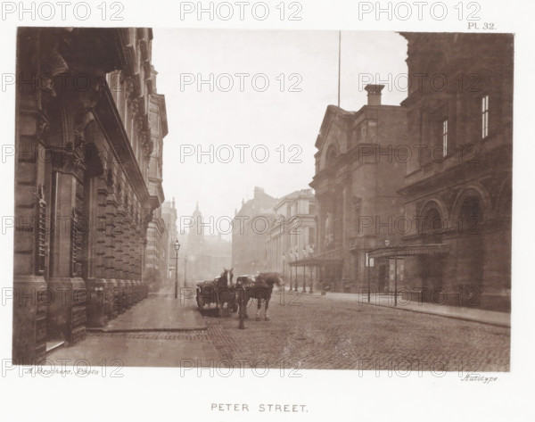 View of Peter Street in Manchester, Peter Street, page, photomechanical print, number: 'Pl. 32.', photographer: Brothers, Alfred, Manchester, cliché maker: anonymous, c. 1868 - in or before 1878, printer (person), paper, collotype, photoprint, height 129 mm x width 189 mm, Print after page 30., street, four-wheeled, animal-drawn vehicle, eg: cab, carriage, coach, A sepia-toned street scene shows tall stone buildings with ornate facades lining both sides of a cobbled road, gas street lamps along the pavement, a horse-drawn carriage with two horses on the road, distant domed and spired rooftops visible through light haze, arched windows and doorways on the nearer buildings, and a covered entrance with columns on the right.
