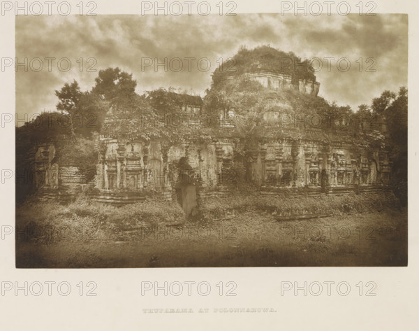 Ruins of the Thuparama temple at Polonnaruwa, Sri Lanka, page, photomechanical print, title: 'THUPARAMA AT POLONNARUWA.', photographer: Henry William Cave, Polonnaruwa, cliché maker: anonymous, 1896, South Asia, paper, Woodburygravure, height 124 mm x width 193 mm, Print for page 113., temple, shrine, Hinduism, Buddhism, Jainism, ruin of a building, architecture, A sepia-toned photograph of an ancient stone structure partially covered by vegetation, showing weathered carved facades with recessed niches and decorative moldings, a central arched doorway, and layered stone terraces; plants and vines grow over many surfaces and trees rise behind and above the structure under a cloudy sky.