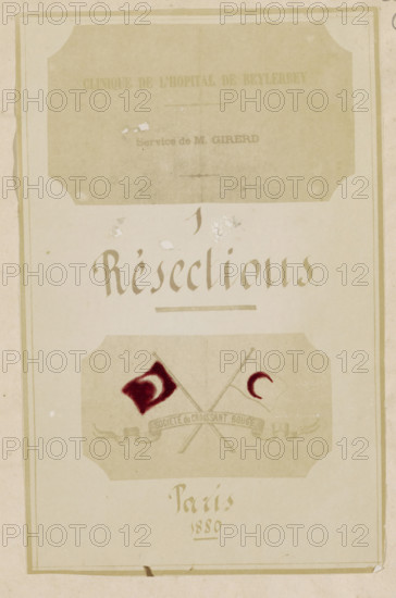 Photo reproduction of the title page of the book, photograph, reproduction, page, after design by anonymous, 1880, photographer, paper, albumen print, hand coloring, height 186 mm x width 118 mm, book, title-page, A vertical, aged paper document with a faded rectangular decorative border and rounded corner cutouts, showing a pale beige background and darker beige panels. In the upper portion there is a large faded rectangular panel with an even paler interior and some small scuffs and speckles. Below it, centered stylized calligraphic lettering appears in a darker beige tone. Further down a horizontal emblem panel contains two crossed staffs and two small flags rendered with dark red paint and pale beige fills, and a ribbon-like banner beneath the crossing. The lower area shows faint cursive-style lettering in the same darker beige and a thin horizontal rule, with signs of foxing, small stains, and slight tears along the bottom edge. The overall image exhibits worn paper texture, disco...