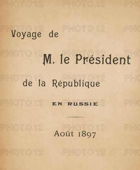 Voyage de M. le Président de la République en Russie, Août 1897, book, writer (clerical worker): Paul Belon, photographer: Paul Gers, 1897, writer (clerical worker), textile materials, paper, linen (material), printing, collotype, height 277 mm x width 200 mm x thickness 11 mm, A tan, slightly mottled paper background with dark serif characters arranged in several horizontal lines across the upper and middle areas, including a larger central line of bold, stylized letters and smaller lines above and below, and a small decorative flourish in the center; the lower portion of the page is mostly empty with the paper texture visible.