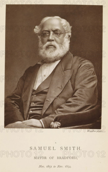 Portrait of Samuel Smith, Samuel Smith, mayor of Bradford, page, photomechanical print, inscription: 'Nov. 1850 to Nov. 1851.', photographer: Appleton & Co., Bradford (England), cliché maker: anonymous, c. 1871 - in or before 1881, paper, Woodburytype, Woodburytypepie, height 116 mm x width 91 mm, historical persons (portraits and scenes from the life) ((full) bust portrait), A seated older man with a full white beard and wavy white hair wears round spectacles and a dark suit with a waistcoat and a light shirt, his hands folded in his lap and one arm resting on an upholstered armrest, shown against a plain dark background.