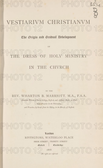 Vestiarium christianum the origin and gradual development of the dress of holy ministry in the church, book, inscription: 'ex libris SFJ', writer (clerical worker): Wharton Booth Marriott, publisher: Rivington, London, 1868, writer (clerical worker), textile materials, pasteboard, paper, linen (material), printing, albumen print, color on cut, lithography, woodcut, height 252 mm x width 161 mm x thickness 43 mm, A cream-colored aged book page with centered printed lines of large serif and blackletter type, showing a bold title near the top, a smaller decorative subtitle beneath it, and other lines of text descending the page; there are small brown spots and faint stains scattered across the paper, a vertical shadow or darker edge along the left margin, and a handwritten pencil mark near the top right edge.