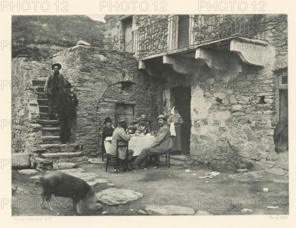 Une excursion en Corse, book, writer (clerical worker): Roland Napoleon Bonaparte, Paris, 1891, writer (clerical worker), paper, printing, photoaquatint, height 279 mm x width 223 mm x thickness 32 mm, A stone courtyard scene showing a rough stone building with an arched doorway and a balcony with a metal railing, a flight of stone steps on the left with a man standing partway up and a child lower on the steps, a group of people seated around a table covered with a cloth in the center foreground with dishes and bottles on the table and a seated man facing the camera, a woman standing near the doorway wearing a head covering, scattered stones and debris on the ground, and a pig grazing in the lower left area.