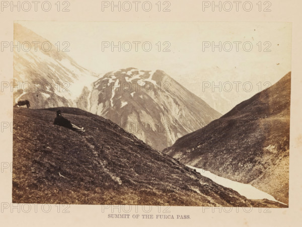 Summit of the Furca Pass, View of the top of the Furka Pass, photograph, page, photographer: Francis Frith, Furka Pass, c. 1855 - in or before 1865, paper, albumen print, height 113 mm x width 171 mm, mountain-range, snow peaks, A sepia-toned mountain landscape showing steep grassy slopes in the foreground and large rocky peaks with patches of snow in the background, with a narrow strip of snow or ice running down a valley between the slopes; a person reclining on the nearer hillside wearing dark clothing and a hat, and an animal grazing farther up the left slope; the sky appears pale and light above the mountains.