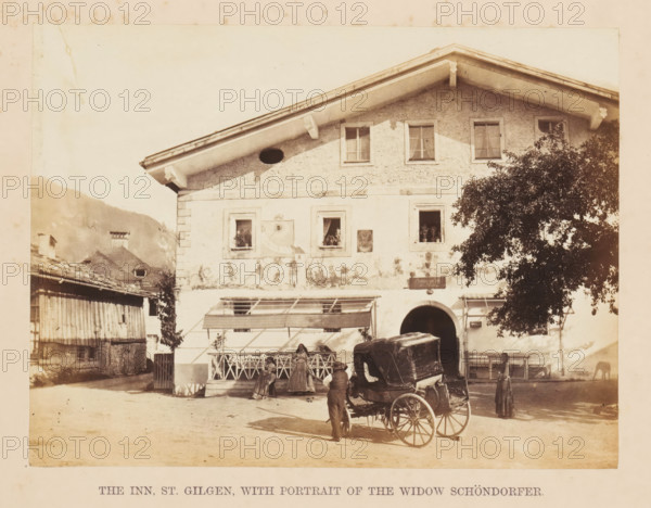 The Inn, St. Gilgen, with portrait of the Widow Schöndorfer, View of an inn in Sankt Gilgen, photograph, page, photographer: Francis Frith, Sankt Gilgen, c. 1855 - in or before 1865, paper, albumen print, height 121 mm x width 163 mm, hotel, hostelry, inn, four-wheeled, animal-drawn vehicle, eg: cab, carriage, coach, A two-story building with a steep gabled roof occupies the center, its upper facade showing textured plaster and several rectangular windows with curtains, while the lower facade features framed windows, decorative painted motifs, and an arched entrance. A covered horse-drawn carriage with large spoked wheels sits in front of the entrance, and a man stands beside it. A wooden balcony railing runs along part of the front, where a few people in period clothing are gathered. To the right, a large leafy tree partially obscures the building, and to the left older wooden structures and sloped roofs are visible against a hilly background. The foreground is an open dirt area casti...