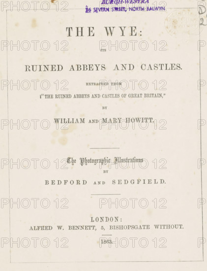 The Wye its ruined abbeys and castles, book, name: 'Walch and Son Bookseller Hobart Town', name: 'Kenneth Coc Burgh-Westra 26 Severn Street, North Balwyn', inscription: 'A parting gift to Eby from Marion Muller 'The lord be with thee'', writer (clerical worker): William Howitt, writer (clerical worker): Mary Howitt, publisher: Alfred William Bennett, London, 1863, writer (clerical worker), textile materials, paper, linen (material), albumen print, color on cut, height 189 mm x width 143 mm x thickness 10 mm, A cream-colored page with a thin rectangular border containing centered printed headings in various serif fonts, some larger and bolder, and some ornate; there are small brownish age spots and faint stains scattered across the paper; a purple oval stamp and purple handwritten mark appear near the top edge; a faint embossed circular seal is visible near the top right; horizontal rules separate some sections; overall the layout shows multiple lines of centered typographic elements wi...