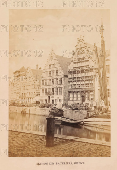 Maison des bateliers, Ghent, photograph, page, c. 1856 - in or before 1866, photographer, paper, albumen print, height 170 mm x width 118 mm, street, façade (of house or building), Gildehuis der Vrije Schippers, A waterside street scene shows a row of tall, ornate stone buildings with stepped gables and decorative facades facing a canal. Several boats are moored along the canal edge, some tied to posts and a rounded bollard in the foreground, with reflections visible in the water. The cobbled pavement runs along the canal in the foreground. On the buildings, many windows and carved architectural details are visible, and a tall mast or pole stands beside one of the structures. Wagons and wooden carts are lined along the quay beside the buildings. The overall image has a sepia tone.