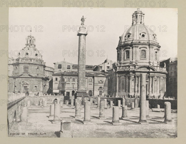Forum of Trajan, page, photomechanical print, photographer: Samuel J. Beckett, c. 1890 - c. 1900, Rome, paper, collotype, photoprint, height 153 mm x width 197 mm, landscape with ruins, facade (of house or building), A grayscale photograph showing a large open archaeological site with many cylindrical stone columns of varying heights standing on a flat, sandy ground, a tall decorated column with a statue on top rising near the center, and two large domed classical buildings with ornate facades and round windows behind the site, flanked by multi story buildings with rows of rectangular windows, while small groups of people appear near the buildings and along a raised walkway at the edge of the ruins.