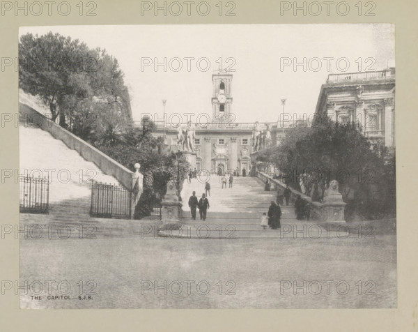 The capitol, page, photomechanical print, photographer: Samuel J. Beckett, Rome, c. 1890 - c. 1900, paper, collotype, photoprint, height 152 mm x width 202 mm, square, circus, staircase, Piazza del Campidoglio, A wide stone staircase leads up to a large classical building with a central clock tower and ornate façades, flanked by statues of figures on pedestals and lamp posts; trees and bushes line the sides of the stairs, and wrought iron gates and stone balustrades are visible near the lower landings; several people in period clothing are walking up and down the steps, including pairs and single figures, while sculpted lion figures sit on plinths at the base of the stairs.