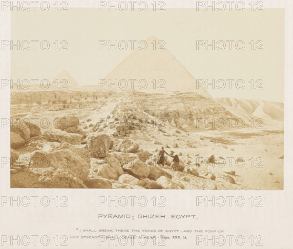 Pyramid, Giza Egypt, View of the Pyramid of Cheops, photograph, page, inscription: ''I shall break there the yokes of Egypt: and the pump of her strength shall cease in here.' Ezek. XXX. 18.', photographer: Francis Frith (possibly), Giza, c. 1850 - c. 1865, North Africa, paper, albumen print, height 104 mm x width 157 mm, Egyptian pyramids (Wonder of the World), Pyramids of Giza, A sepia-toned photograph shows a desert landscape with large stone blocks and rocky terrain in the foreground leading toward two pyramids in the background, one pyramid larger and closer and the other smaller and more distant, with scattered rubble and a low stone cairn or mound on the slope; two figures in traditional clothing stand among the rocks near the center, one standing and one seated, with undulating sandy slopes and eroded cliffs visible to the right and a pale sky filling the upper portion of the image.