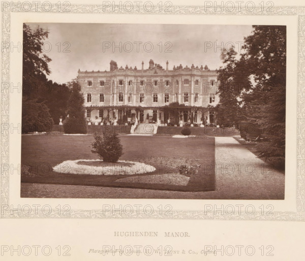 Hughenden manor, page, photomechanical print, photographer: Henry W. Taunt, High Wycombe, c. 1876 - in or before 1881, printmaker, Buckinghamshire, paper, Woodburytype, height 96 mm x width 145 mm, rural housing, eg country-house, villa, cottage, A sepia-toned photograph of a large three-story brick manor centered in a landscaped garden, flanked by tall trees on both sides, with an expansive lawn and gravel path in the foreground; the manor shows rows of windows, a veranda with climbing plants, a central stairway leading up to an entrance, decorative roofline features and chimneys, sculpted shrubs and a circular flowerbed on the lawn, and several potted plants near the path.
