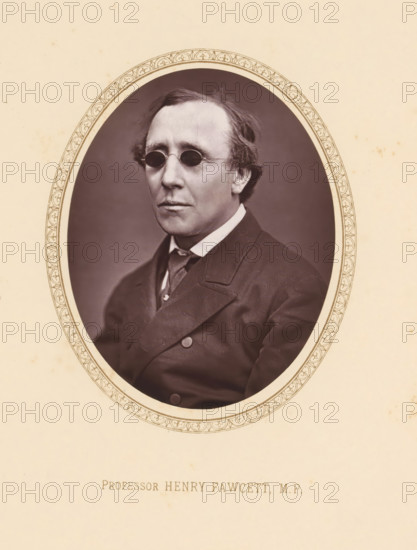 Professor Henry Fawcett, MP, page, photomechanical print, c. 1875 - c. 1880, photographer, printmaker, paper, Woodburytype, height 109 mm x width 81 mm, Person, Henry Fawcett, politician, eg party leader, An oval sepia photograph of a middle-aged man set against a plain darker background, framed by a decorative oval border on a light beige page; the man wears small round dark spectacles, has neatly combed hair with slight waves at the sides, a high-collared shirt with a tie, and a dark double-breasted coat with visible buttons and lapels, and his expression is neutral.
