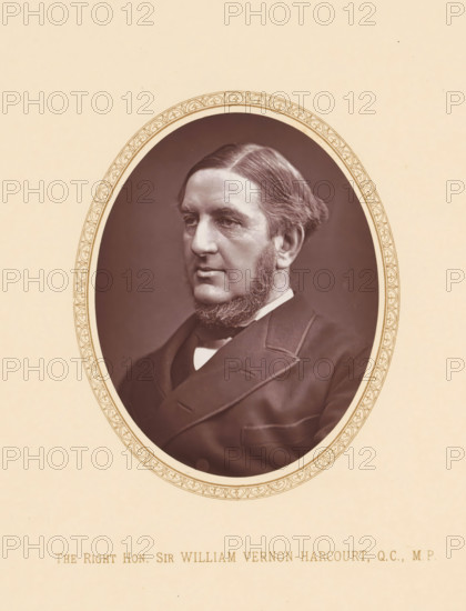 The right hon. Sir William Vernon-Harvourt, QC, MP, page, photomechanical print, c. 1875 - c. 1880, photographer, printmaker, paper, Woodburytype, height 109 mm x width 87 mm, Person, William Vernon Harcourt, politician, eg party leader, An oval sepia portrait of a middle-aged man with neatly combed hair and muttonchop sideburns, wearing a dark suit jacket and a white shirt collar, set against a plain dark background and surrounded by a decorative oval border on a light beige page.