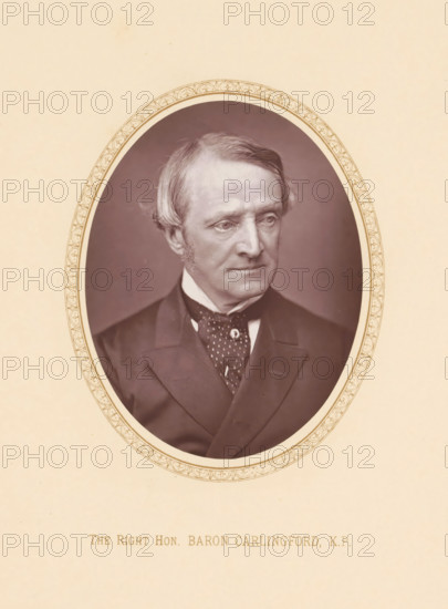 The right hon. Baron Carlingford, KP, page, photomechanical print, c. 1875 - c. 1880, photographer, printmaker, paper, Woodburytype, height 110 mm x width 86 mm, Person, Chichester Parkinson-Fortescue, politician, eg party leader, An oval sepia-toned portrait of an older man with light hair swept to the side and short sideburns, shown from the chest up and wearing a dark suit jacket, a white shirt collar, and a patterned cravat, set within a decorative oval border on a pale background.