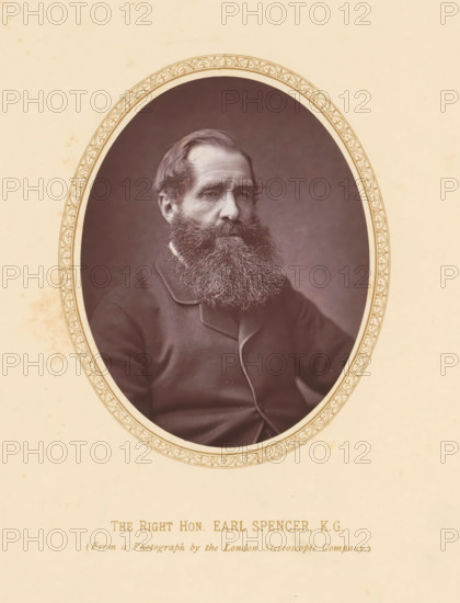 The right hon. Earl Spencer KG, page, photomechanical print, photographer: London Stereoscopic Company, London, c. 1875 - c. 1880, printmaker, paper, Woodburytype, height 108 mm x width 86 mm, Person, John Spencer (5th Earl Spencer), politician, eg party leader, A framed oval photograph of a man with a full beard and mustache, wearing a dark coat with visible lapels, set against a plain dark background, the oval frame having a decorative patterned border and mounted on a light-colored paper with faint stains.
