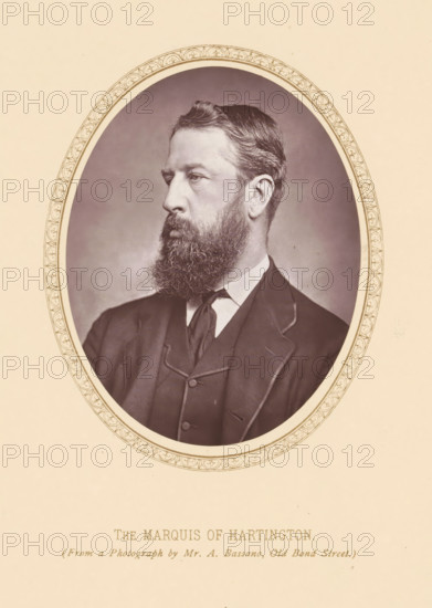 Portrait of Spencer Cavendish, The marquis of Hartington, page, photomechanical print, photographer: Alexander Bassano, London, c. 1877 - c. 1882, printmaker, paper, Woodburytype, height 111 mm x width 87 mm, Person, Spencer Cavendish, politician, eg party leader, A sepia-toned oval portrait of a bearded man in a dark suit and tie set against a plain background, framed by an ornate oval border, with the man shown in three-quarter profile facing left and wearing a jacket with visible lapels and a high-collared shirt.