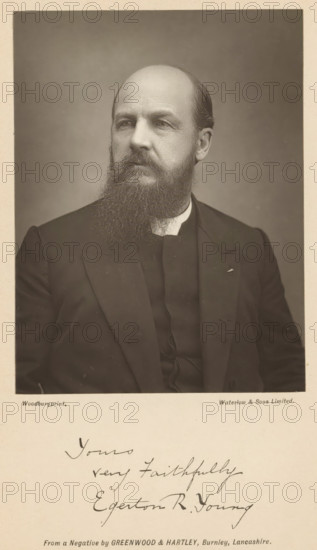 Portrait of Egerton Ryerson Young, page, photomechanical print, inscription: 'Yours very faithfully Egerton R. Young', photographer: Greenwood & Hartley, maker: Waterman, c. 1882 - in or before 1892, paper, Woodburytype, height 117 mm x width 88 mm, Print opposite title page., Person, Egerton Ryerson Young, adult man, spreading the gospel, missionary work, A sepia portrait of a seated man shown from the chest up against a plain background, with a high forehead and a full beard and mustache, wearing a dark suit jacket over a dark vest and a light collar, his head turned slightly to his left and his gaze directed off camera, the image framed by a light border with handwritten script visible below the portrait.