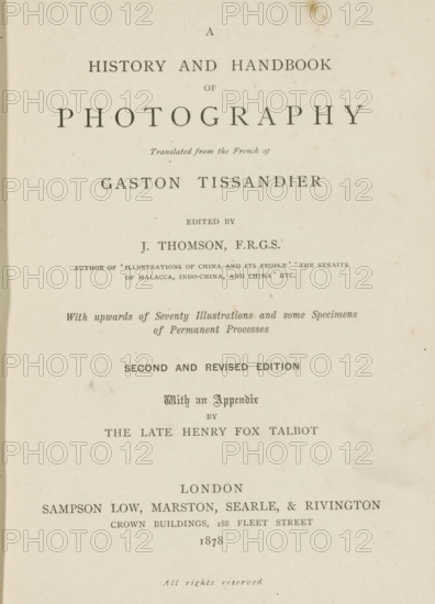 A history and handbook of photography, book, writer (clerical worker): Gaston Tissandier, writer (clerical worker): William Henry Fox Talbot, publisher: Sampson Low, Marston, Searle, & Rivington, London, 1878, writer (clerical worker), textile materials, pasteboard, paper, linen (material), printing, collotype, photoaquatint, height 198 mm x width 147 mm x thickness 35 mm, A vertically oriented aged book page with centered printed lines of varying font sizes and styles on an off-white, slightly stained background, showing a large bold title near the top, smaller italicized and capitalized lines beneath it, and several more centered lines of serif type descending the page with visible spacing between sections, all surrounded by plain margins and a faint darker edge along the left side.