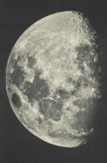 The moon - first quarter, page, photomechanical print, photographer: Lewis Morris Rutherfurd, printer (person): Woodbury Permanent Photographic Printing Company, London, c. 1889 - in or before 1899, printmaker, printer (person), paper, Woodburygravure, height 145 mm x width 97 mm, moon as celestial body, Moon, A large black-and-white image of a crescent planetary surface showing a textured, cratered terrain with varying shades of gray, bright highlights and darker basins, and numerous circular impact marks along the lit terminator against a dark background.