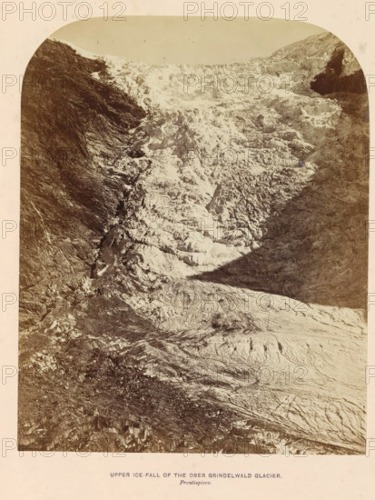 Upper ice-fall of the Ober Grindelwald glacier, photograph, page, inscription: 'Frontispiece.', photographer: Ernest Edwards, Obere Grindelwald Glacier, c. 1850 - in or before 1866, Upper Grindelwald Glacier, paper, albumen print, height 170 mm x width 136 mm, Photo opposite title page., glacier, A vertical sepia-toned photograph showing a steep, rugged glacier descending between dark rocky slopes, with heavily crevassed and ridged ice surfaces occupying the central area and lighter-toned snow and ice contrasted against shadowed rock on either side, the image framed by rounded corners and a pale border.