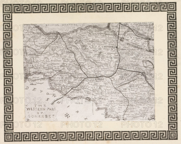 Photo reproduction of a print, depicting a map of West Somerset, reproduction, page, photomechanical print, cliché maker: anonymous, after print by anonymous, c. 1868 - in or before 1873, photographer, after print by, paper, photoaquatint, height 96 mm x width 127 mm, Print on frontispiece., maps of separate countries or regions, Somerset, West Somerset, A rectangular ornate border with a repeating geometric inner pattern and a decorative outer floral scroll surrounds an inset rectangular map that is tilted slightly; the border is dark ink on a pale background and shows corner flourishes and a patterned band running along each side, while the inset map is a grayscale, detailed topographic illustration with winding lines representing roads or rivers, varied shading for terrain, and small clustered marks indicating settlements.