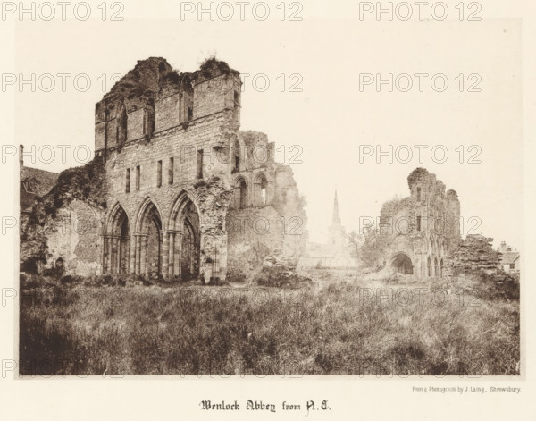 Wenlock Abbey from NE, View of the ruins of Wenlock Priory, page, photomechanical print, photographer: J. Laing, Wenlock Priory, cliché maker: anonymous, c. 1867 - in or before 1877, Shropshire, Much Wenlock, paper, collotype, photoprint, height 137 mm x width 193 mm, ruin of church, monastery, A wide, sepia-toned scene shows the ruins of a large stone abbey with tall, arched openings and partially collapsed walls, vegetation growing on and around the masonry, an overgrown grassy foreground, scattered remnants of arches and window openings, a distant slender spire rising behind the ruins, and a few small buildings partially visible near the edges of the composition.