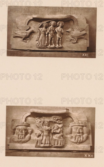 Two carvings in Worcester Cathedral, page, photomechanical print, Above an angel chases Adam and Eve from Paradise between two birds, below Abraham sacrifices Isaac between two faces., number: 'XXI, XXII', c. 1863 - in or before 1873, paper, Woodburytype, height 306 mm x width 244 mm, interior of church, an angel chases Adam and Eve out of paradise with a (flaming) sword, the sacrifice of Isaac (Genesis 22), carving, applied arts, A photograph of two carved wooden panels mounted one above the other on a pale background, each panel featuring a central raised scene flanked by decorative elements; the upper panel shows three standing human figures under a curved canopy with a large bird with outstretched wings carved to each side, the figures wearing draped garments and the central figures appearing unclothed from the waist up, with carved bases beneath their feet; the lower panel shows a central standing figure holding an object above a smaller seated figure, flanked by two large carved ...