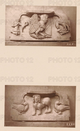 Two carvings in Worcester Cathedral, page, photomechanical print, Above a mythical creature between a figure and two birds of prey, below a sphinx between two birds., number: 'XXXI, XXXII', c. 1863 - in or before 1873, paper, Woodburytype, height 306 mm x width 244 mm, interior of church, fabulous animals (sometimes wrongly called 'grotesques'), 'Mostri' (Ripa), sphinx (lion, woman), 'Sfinge' (Ripa), carving, applied arts, A vertical image shows two separate rectangular stone relief panels mounted on a pale background, one near the top and one near the bottom. The upper panel features a central carved figure with wings and a hooded human head, flanked on the left by a small human figure and an animal head, and on the right by a bird-like creature facing downward that appears to be holding something in its beak. The lower panel depicts a central composite creature with a human head and a lion-like body standing between two large facing birds with rounded bodies and detailed feathering. ...