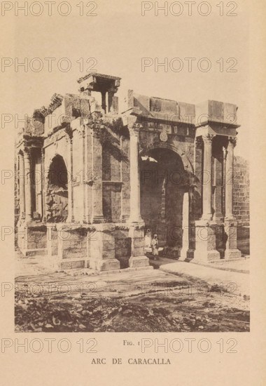 Arc de Caracalla, View of the Arch of Caracalla in Tébessa, page, photomechanical print, number: 'Fig. I', Tébessa, maker: Berthaud Frères, France, c. 1884 - in or before 1894, photographer, North Africa, paper, collotype, photoprint, height 148 mm x width 109 mm, triumphal arch, A sepia-toned photograph shows a large stone archway structure with tall columns and carved architectural details; the stone surfaces appear weathered and some sections are broken or crumbling. Two figures stand beneath the arch, one wearing a long garment and the other shorter, positioned near the shadowed interior. The foreground shows a rough, uneven ground with scattered stones and tracks, and the background above the structure is an empty sky.