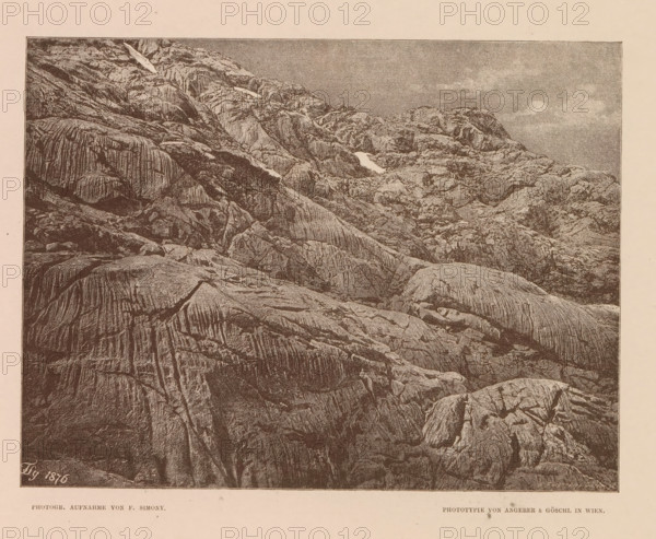 View of the Wildkarspitze, Partie im Wildkar, page, photomechanical print, number: 'XIII.', photographer: Friedrich Simony, Austria, cliché maker: Angerer & Göschl, C., Vienna, publisher: Eduard Hölzel, 1876, clichémaker, Lower Austria, paper, autotypie, height 148 mm x width 196 mm, mountain-top, peak, Tirol, Wildkarspitze, A sepia-toned image showing a large expanse of rugged rock formations filling most of the frame, with layered and grooved surfaces, ridges, cracks, and varied textures; a few pale patches contrast with the darker rock, and a sky with subtle cloud shapes appears above the rocky slopes.