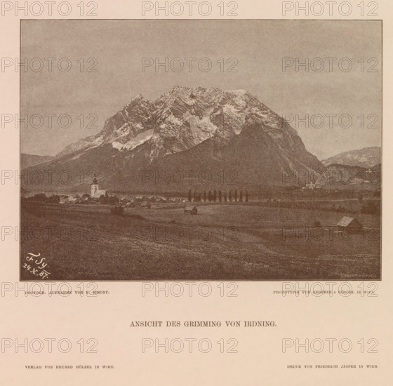 Ansicht des Grimming von Irdning, View of the Grimming, page, photomechanical print, number: 'XV.', photographer: Friedrich Simony, Austria, cliché maker: Angerer & Göschl, C., Vienna, publisher: Eduard Hölzel, 1887-10-24, Lower Austria, paper, autotypie, height 138 mm x width 190 mm, mountain-top, peak, Dachstein (Salzburg), Grimming, A sepia-toned image of a mountainous landscape with a large, rugged snow-dusted peak occupying the upper center and right, a darker forested slope in front of the mountain, and a flat valley in the foreground containing small clustered buildings, a church with a steeple, scattered houses, a line of tall slender trees, and a few isolated farm structures.