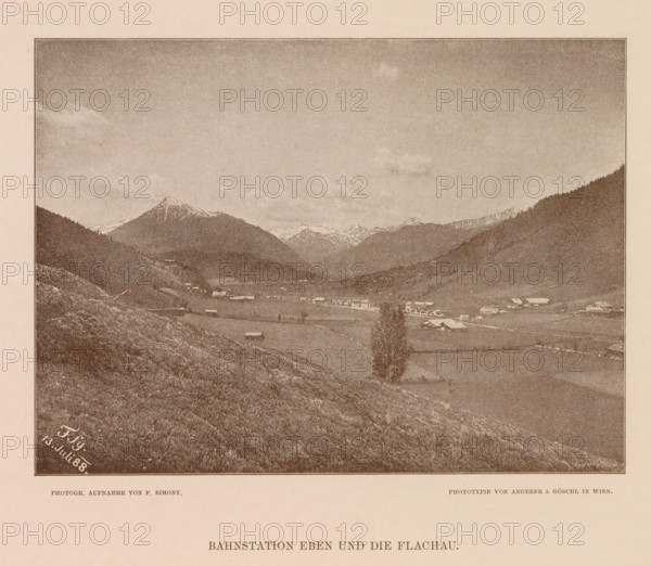 View of Flachau, Bahnstation eben und die Flachau, page, photomechanical print, number: 'XVII.', photographer: Friedrich Simony, Salzburg (city), cliché maker: Angerer & Göschl, C., Vienna, publisher: Eduard Hölzel, 1888-07-13, Lower Austria, paper, autotypie, height 142 mm x width 191 mm, city-view in general, 'veduta', Flachau, A sepia-toned landscape photograph framed by a thin dark border shows a wide valley flanked by sloping hills and distant snow-capped mountains under a mostly clear sky with a few clouds. In the valley there are scattered small buildings and farm structures with open fields and patches of trees; a single taller tree stands near the foreground. The foreground consists of a grassy, rocky slope leading down into the valley, and the image is mounted on a pale background with printed captions visible below the framed photograph.