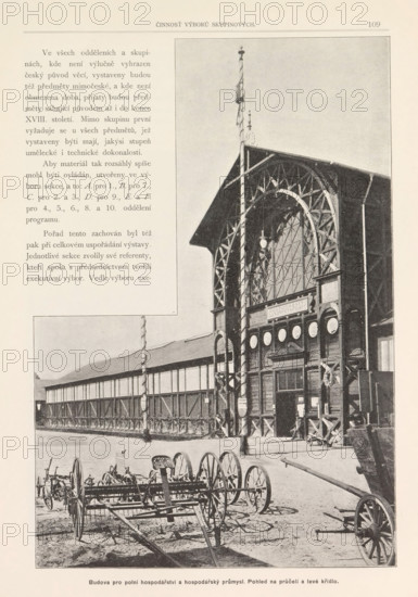 Exterior of the building for economic affairs in Prague, Budova pro polni hospodarstvi a hospodarsky prumysl. Pohled na pruceli a levé kridio, page, photomechanical print, Prague, clichémaker: Carl Bellmann, c. 1888 - in or before 1893, photographer, paper, autotype, height 275 mm x width 190 mm, façade (of house or building), A sepia-toned photograph shows a large ornate wooden building facade with a tall arched window and decorative trusses, a flagpole rising above the roof, and circular medallions or plaques along the upper front; in front of the building yard equipment and wheeled agricultural machinery are arranged on bare ground, with a long low wing of the building extending to the left and a covered walkway or fence running along it.