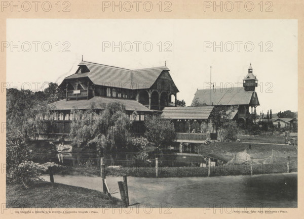 Pohled na pavillony rybárský, lesnický a lovecký vseobecné zemské jubilejní výstavy v Praze r. 1891, Exterior of the fishing, hunting and forestry pavilion in Prague, page, photomechanical print, photographer: Heinrich Eckert, Výstavište, cliché maker: Carl Bellmann, Prague, 1891, paper, collotype, photoprint, height 173 mm x width 262 mm, temporary exhibition, 'Salon', facade (of house or building), A large wooden building with steep shingled roofs and covered balconies stands beside a pond, surrounded by trees and shrubbery, with a covered walkway and an adjacent tower-like structure topped by a small cupola; a grassy bank and a fence run along the water’s edge, a small rowboat is on the pond near the building, and reflections of the structure and vegetation appear in the water.