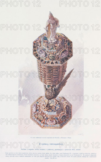 Z výstavy retrospektivni, Chalice, page, photomechanical print, Prague, cliché maker: Husnik & Häusler, c. 1891 - in or before 1895, photographer, paper, color autotype, height 226 mm x width 120 mm, pots, A vertically oriented image of an ornate chalice shown against a pale background, with a decorative octagonal base and matching octagonal cup connected by a faceted stem; the base and cup surfaces are richly embellished with colorful enamel, gem-like ovals, and intricate floral and figurative reliefs, and a sculpted bird figure appears between the stem and base with textured feathers; perched atop the cup is a small carved figurine wearing a pointed hat and draped garment, and the entire object casts a subtle shadow on the surface beneath.