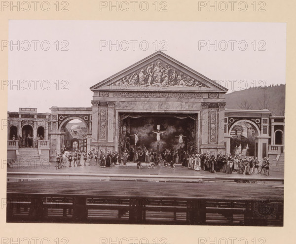 The crucifixion, page, photomechanical print, inscription: 'Gemeinde Oberammergau Passionsspiel 1890', photographer: Carl Stockmann, Oberammergau, cliché maker: anonymous, c. 1885 - in or before 1890, Bavaria, paper, collotype, photoprint, height 167 mm x width 227 mm, group of actors, troupe, actors on the stage, the crucifixion of Christ: Christ's death on the cross, Golgotha (Matthew 27:45-58, Mark 15:33-45, Luke 23:44-52, John 19:25-38), A wide stage set resembling a classical stone façade with a triangular pediment decorated with sculpted figures sits center; below the pediment an ornate frieze and two large fluted pilasters frame a central opening where a painted backdrop shows three suspended figures and a crowd of people in period costumes gathered on the stage. On either side of the central structure are arched openings and colonnaded walkways with figures standing and seated, and groups of people in costume occupy the stage foreground including soldiers, clergy, and other att...