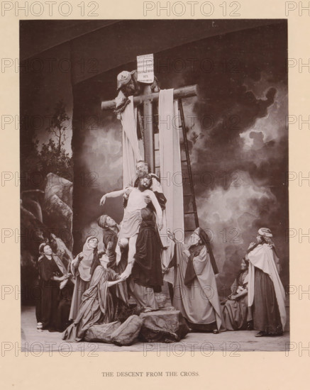 The descent from the cross, page, photomechanical print, inscription: 'Gemeinde Oberammergau Passionsspiel 1890', photographer: Carl Stockmann, Oberammergau, cliché maker: anonymous, c. 1885 - in or before 1890, Bavaria, paper, collotype, photoprint, height 218 mm x width 178 mm, group of actors, troupe, actors on the stage, descent from the cross: Christ is taken down from the cross, usually by Nicodemus and Joseph of Arimathaea who are standing on the ladders (both arms of Christ detached), A sepia-toned staged scene shows a group of robed figures gathered around a wooden cross set against a painted cloudy backdrop, with a ladder leaning against the cross and a cloth draped over the horizontal beam; a central bearded man supports the limp body of another man while several other figures reach up and cradle him, some kneeling and some standing, their garments flowing with folds and head coverings of varied styles; a small rocky foreground and scattered props sit at the base of the scen...