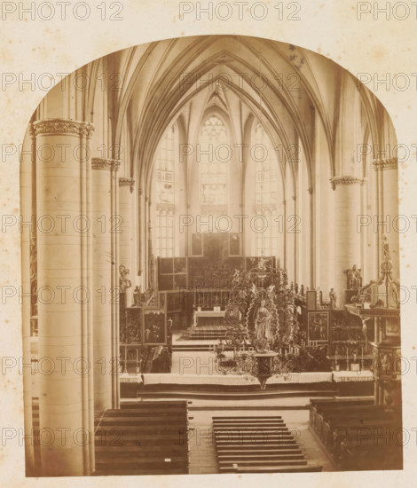 Interior of the St. Nicholas Church in Kalkar, photograph, page, photographer: Friedrich Brandt, St. Nicholas Church (Kalkar), c. 1870 - in or before 1880, North Rhine-Westphalia, Kalkar, paper, albumen print, height 175 mm x width 151 mm, interior of church, parts of church interior: choir, A sepia photograph showing the interior of a Gothic-style church with tall pointed arches and ribbed vaulted ceiling, large stained glass windows at the far end, clustered columns with decorative capitals along the nave, rows of wooden pews leading toward an ornate altar area, a central altar flanked by carved panels and statuary, and an elaborate hanging chandelier with a sculpted figure among intricate metalwork.