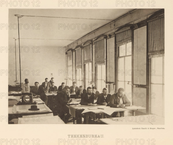 Drawing Office, Employees in the drawing office of the machine factory of Gebroeders Stork & Co, page, photomechanical print, number: 'No. 2.', Hengelo (Overijssel), maker: Emrik & Binger, Haarlem, c. 1884 - in or before 1894, photographer, paper, collotype, photogravure, height 152 mm x width 205 mm, factory-building, drawing (industrial process), A sepia-toned room filled with long tables where men sit closely together working over large sheets of paper, many leaning forward with pens or drawing instruments in hand; the men wear dark suits and some have facial hair, and a few stand near the back; tall windows with striped roller shades line one wall, and simple light fixtures with exposed wiring run along the ceiling; near the foreground a hat rests on a stack of plans and drafting tools and instruments are visible on the tables.